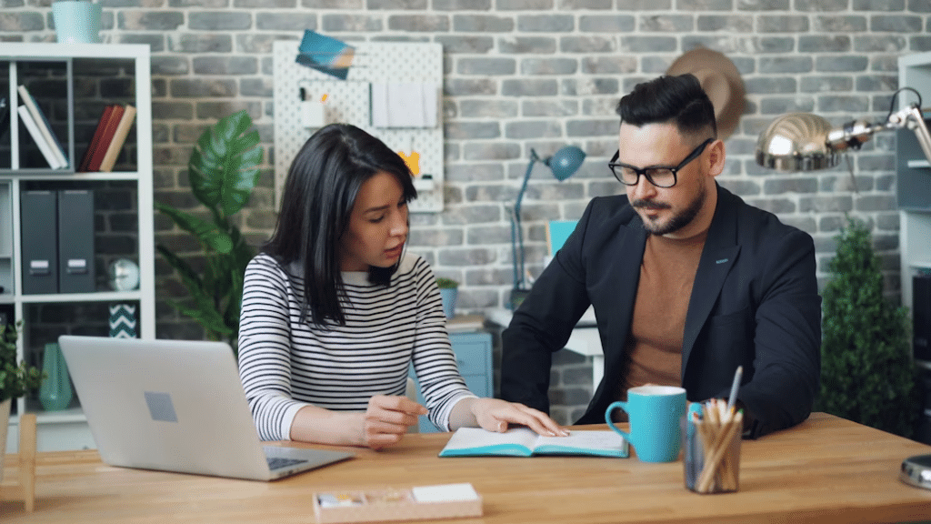 Man and woman calmly discussing financial habits at home.