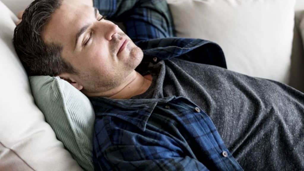 Man asleep on the couch mid movie
