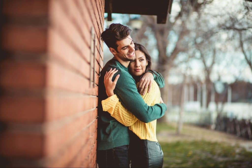 A man and woman hugging each other