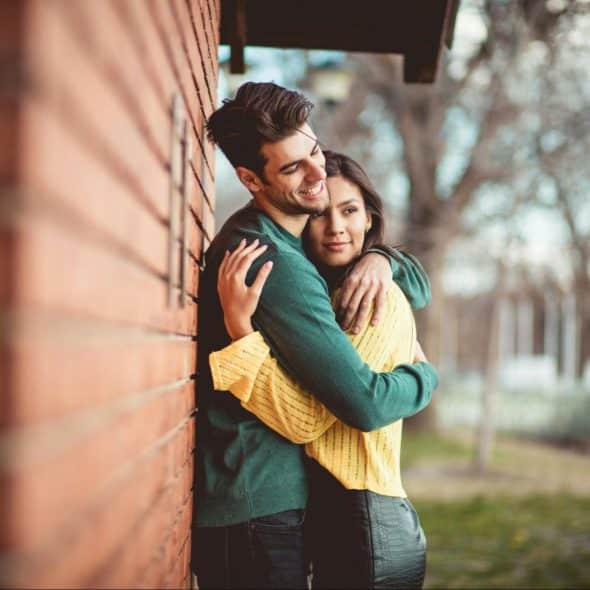 A man and woman hugging each other