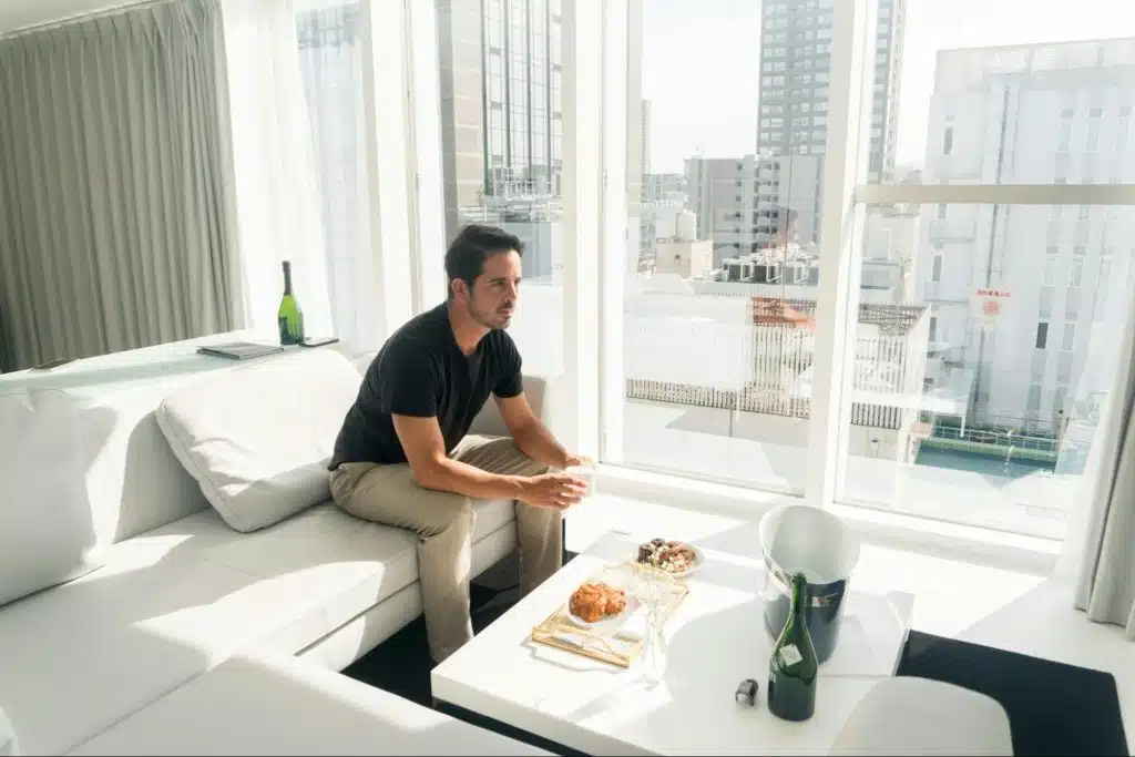 A man eating at the living room.