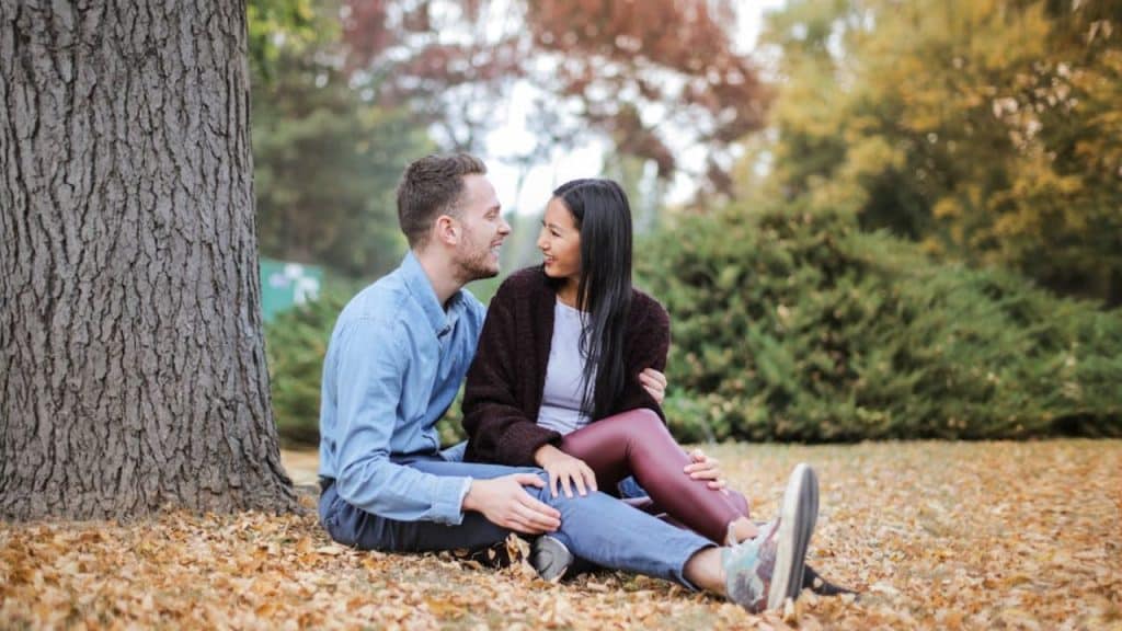 A woman talking candidly to a man during a quiet moment in a park