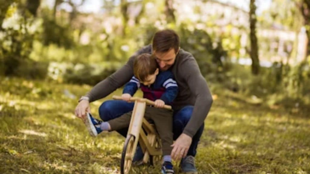 A man helping a child at the park