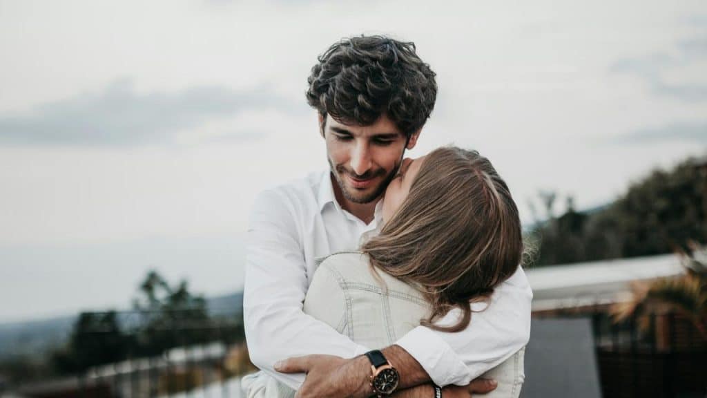 A couple embracing outdoors.