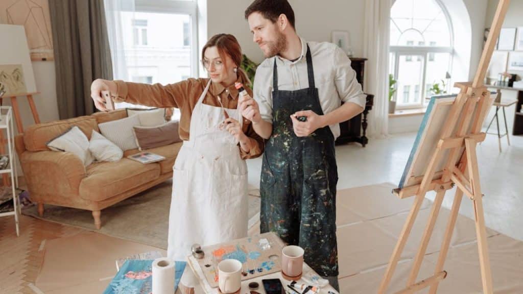 Couple quietly painting side by side in a calm art studio, creating emotional safety.
