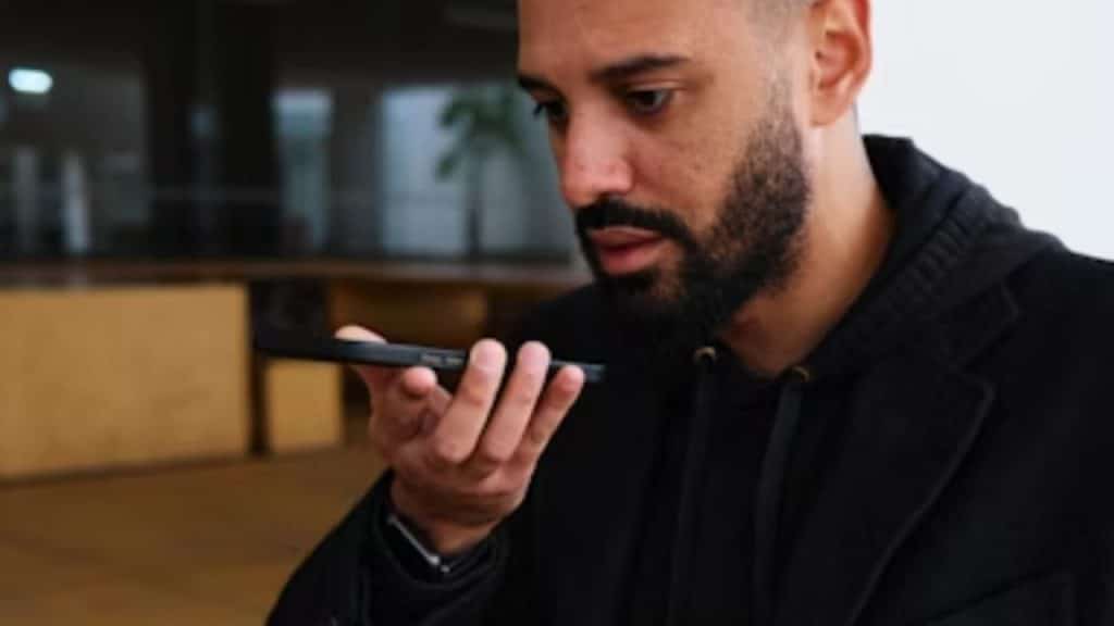 Man recording a short voice message on his phone.