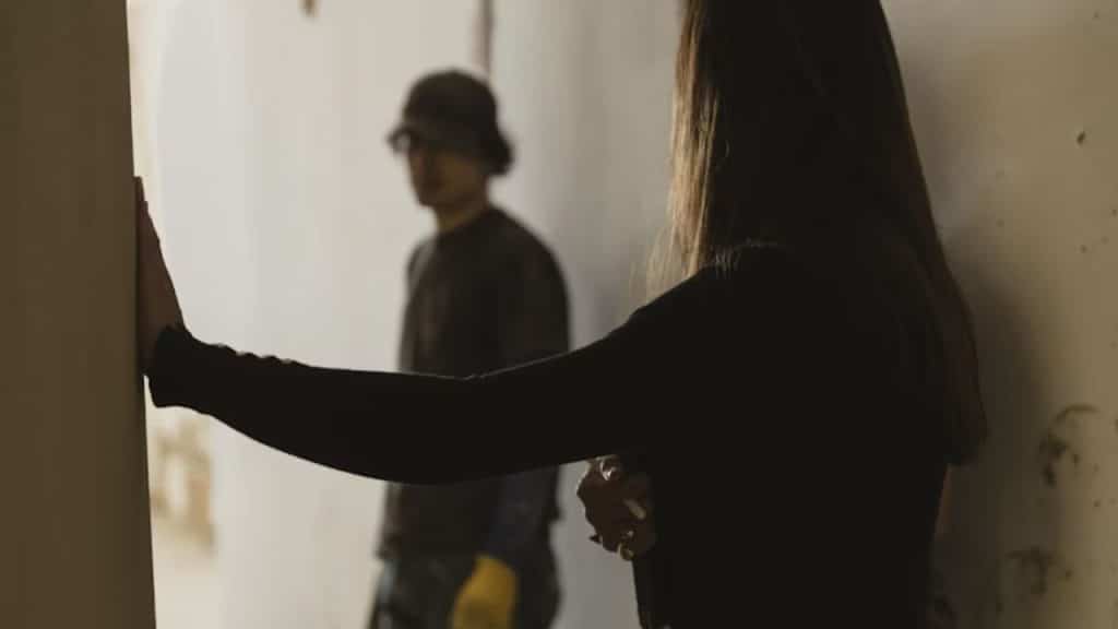 Man working on a passion project while his partner watches from afar.