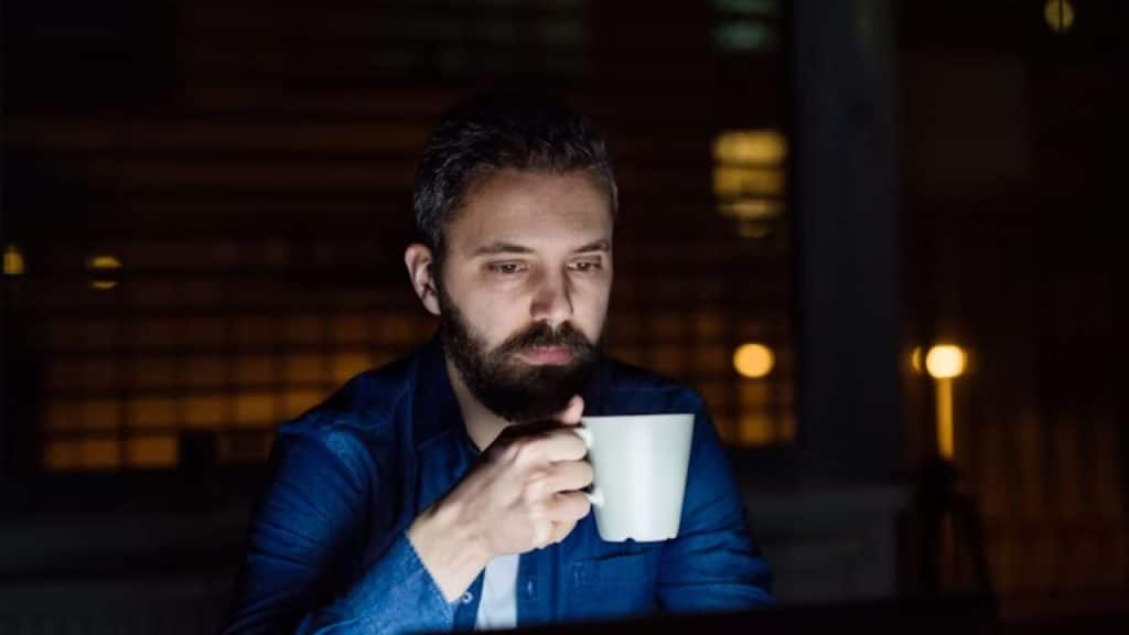 Man using coffee as an energy fix but still feeling tired.