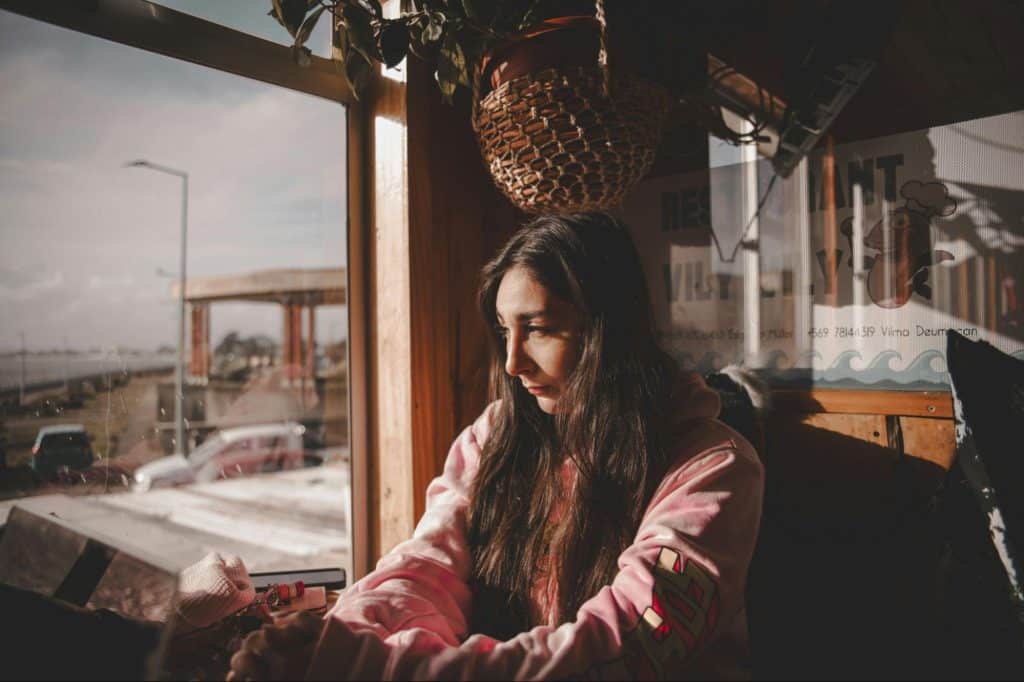 A woman looking at the window.
