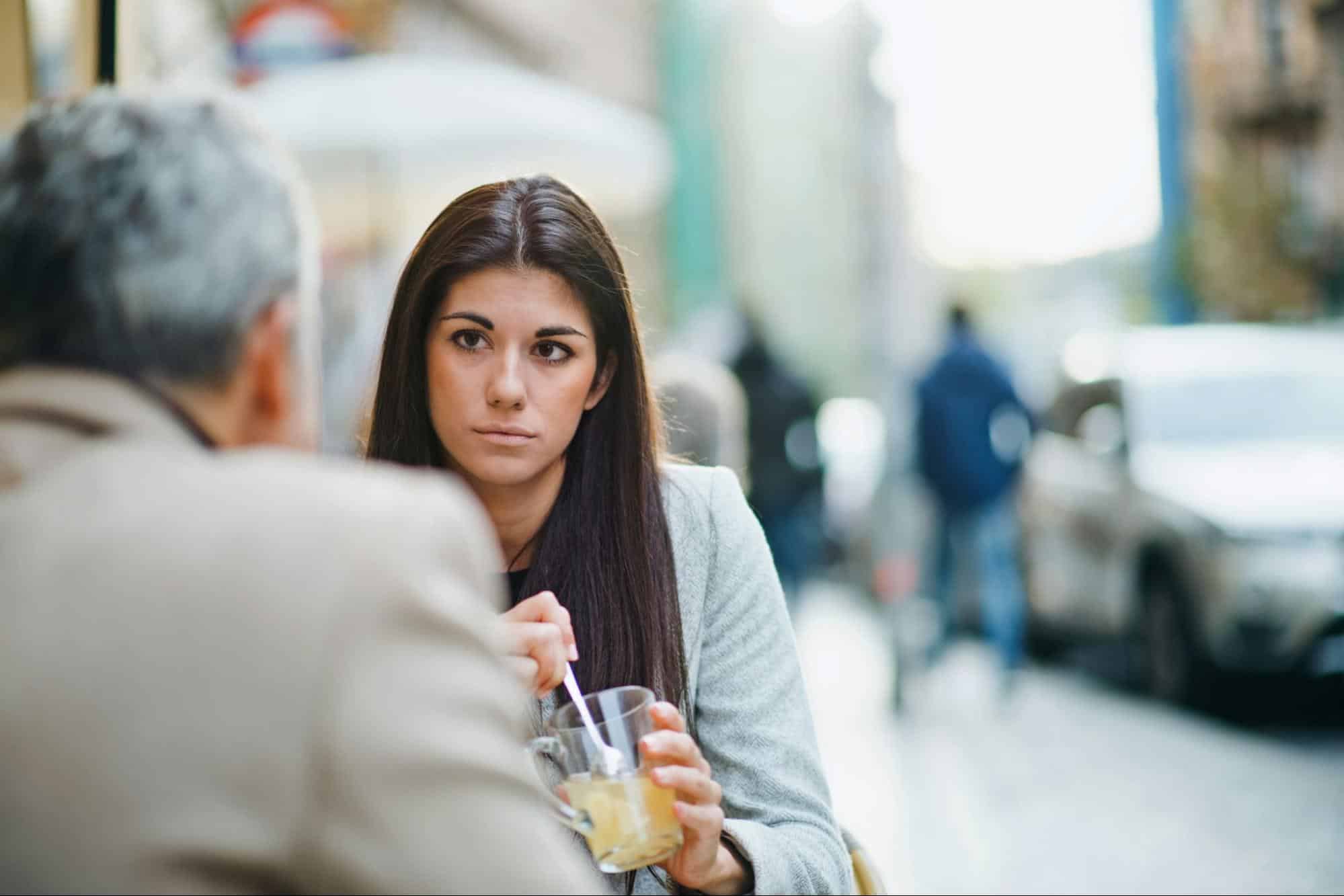 A man talking to a woman in a serious way.