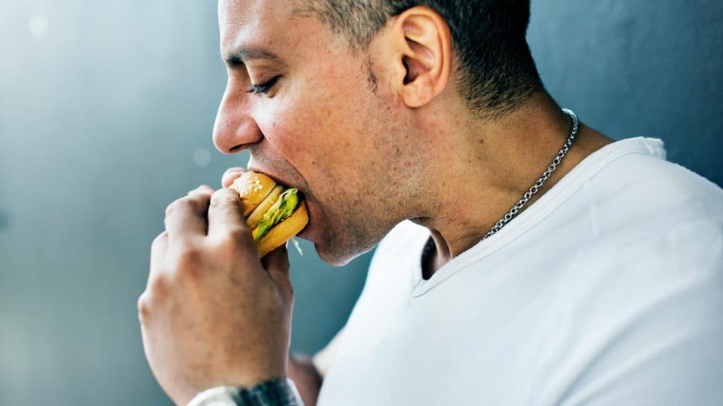 A man eating a burger.