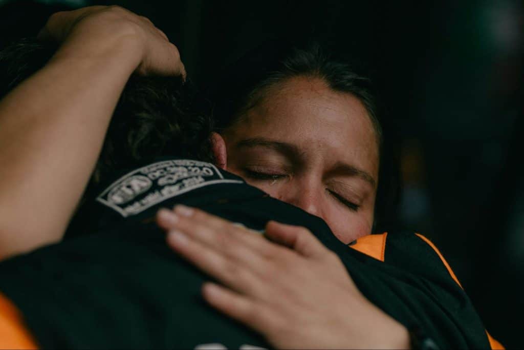A woman crying while hugging  man