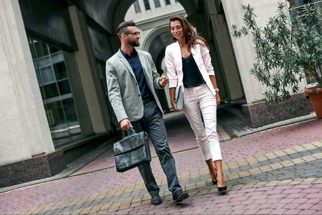 A man and woman walking outside