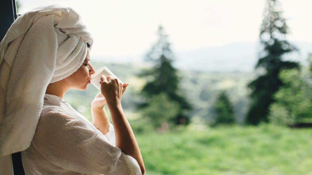 A woman enjoying coffee after a shower