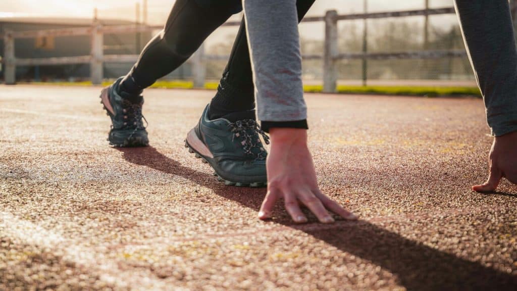 A person getting ready for a sprint