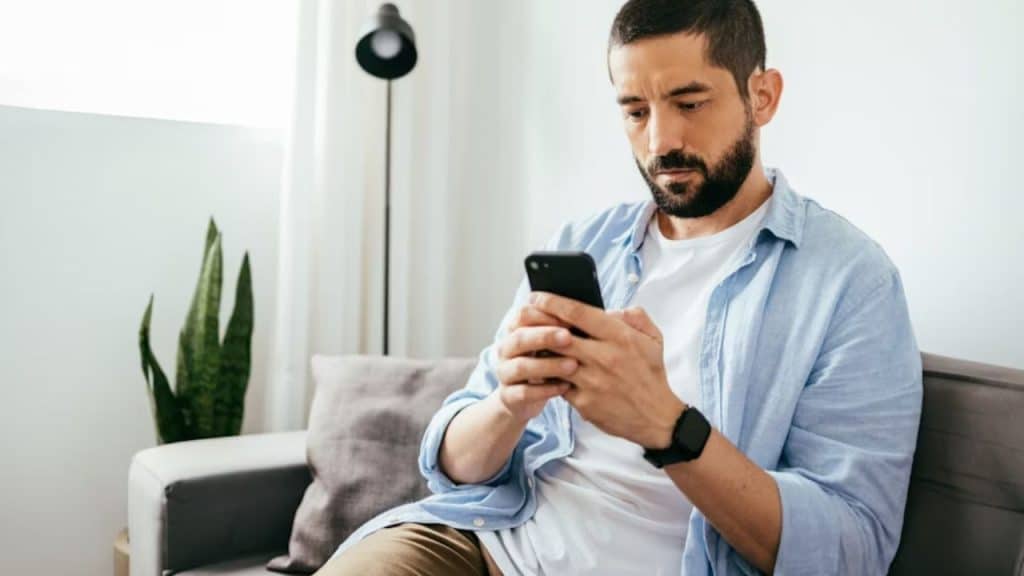 Man using financial tech to stay on budget.