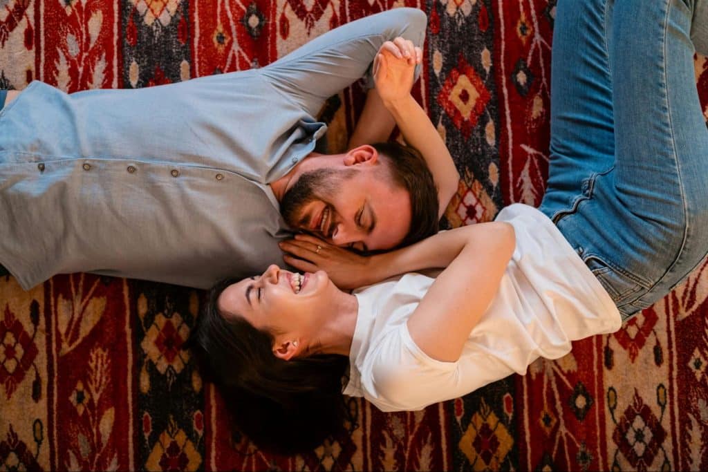 A man and woman laying on the floor.