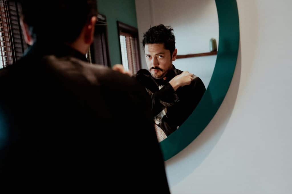 A man looking at the mirror.