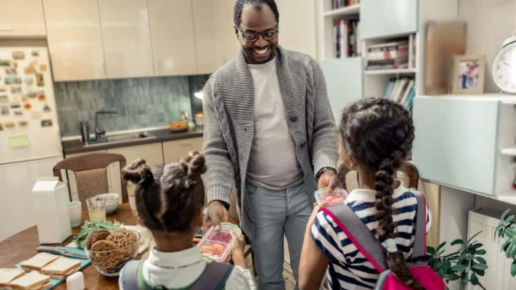 Father supporting teen’s physical wellness with care and guidance by preparing healthy food
