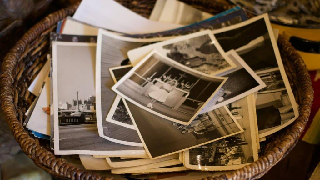 A basket of vintage black-and-white photographs.