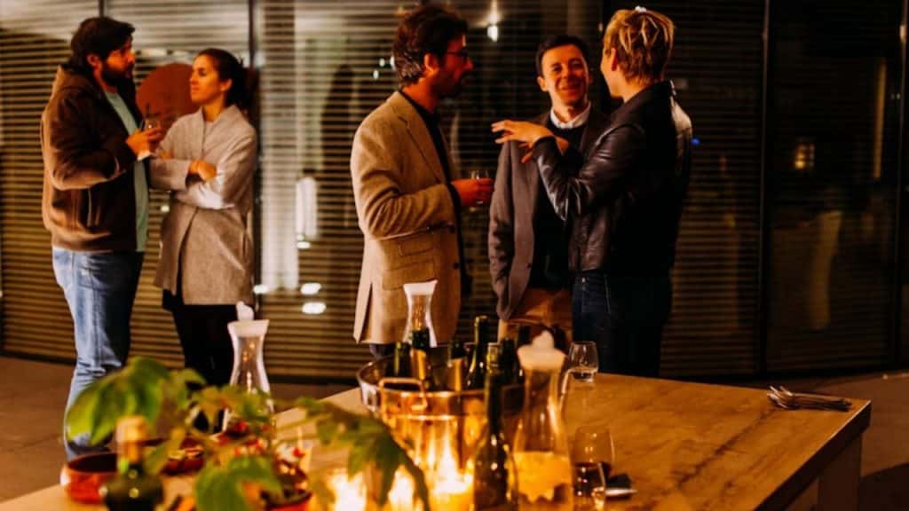 Man respectfully defending his partner’s reputation or decisions in a social setting