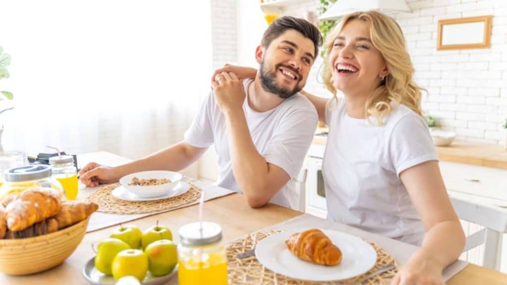 Couple enjoying their breakfast together, relaxed and happy