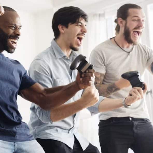 Group of men enjoying video games with laughter in a cozy space