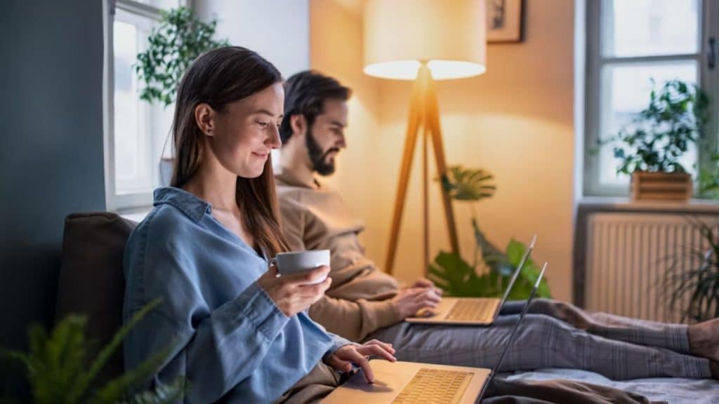 A couple happily doing their own things in the same room
