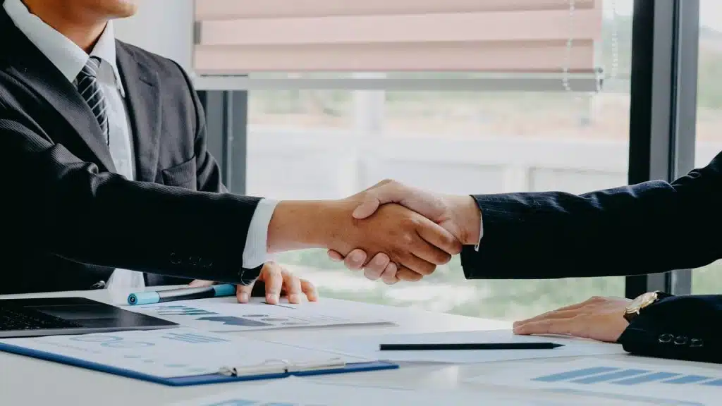 Two people shaking hands at work