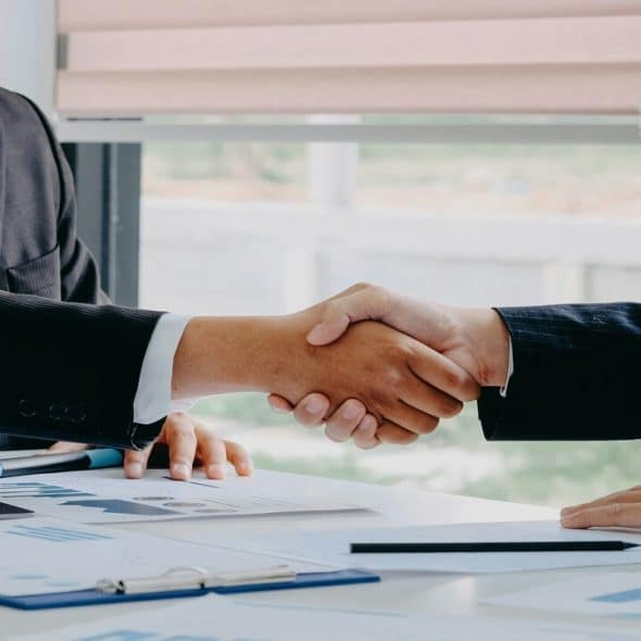 Two people shaking hands at work