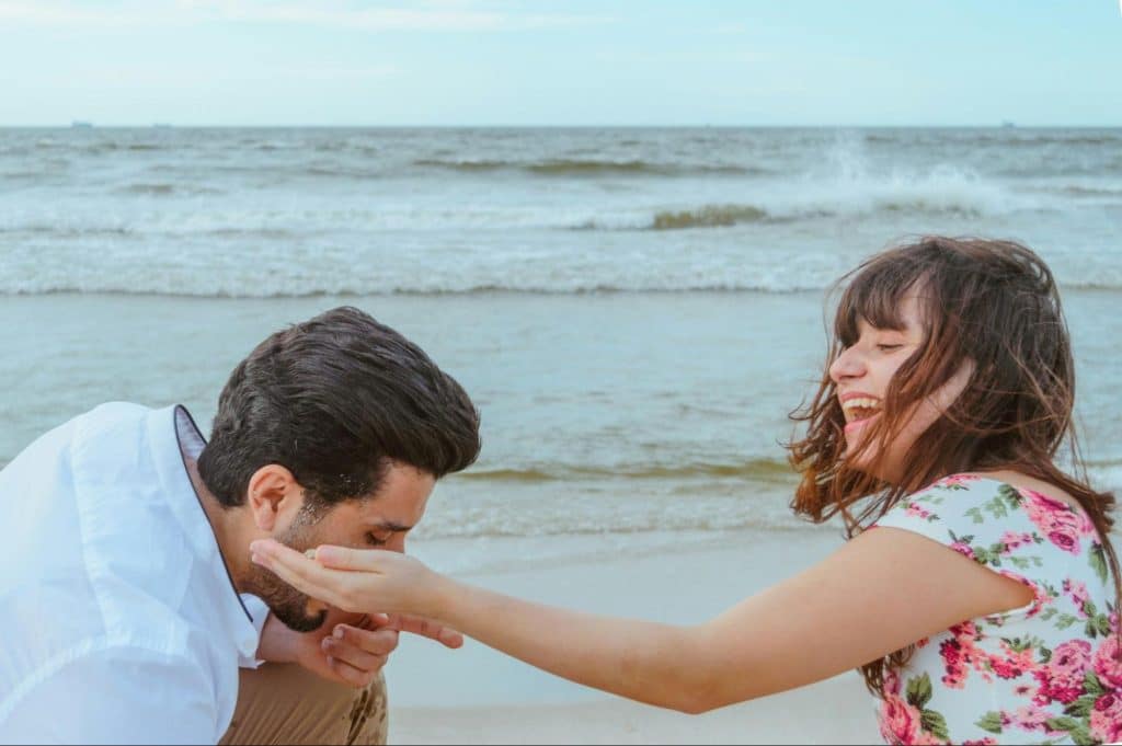 A man and woman happy together at the beach