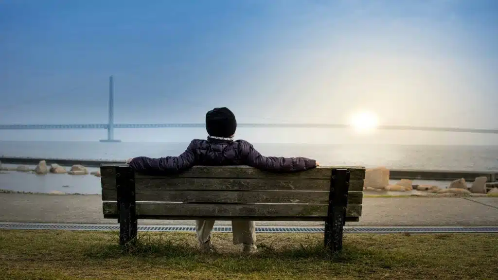 A person relaxing near a body of water