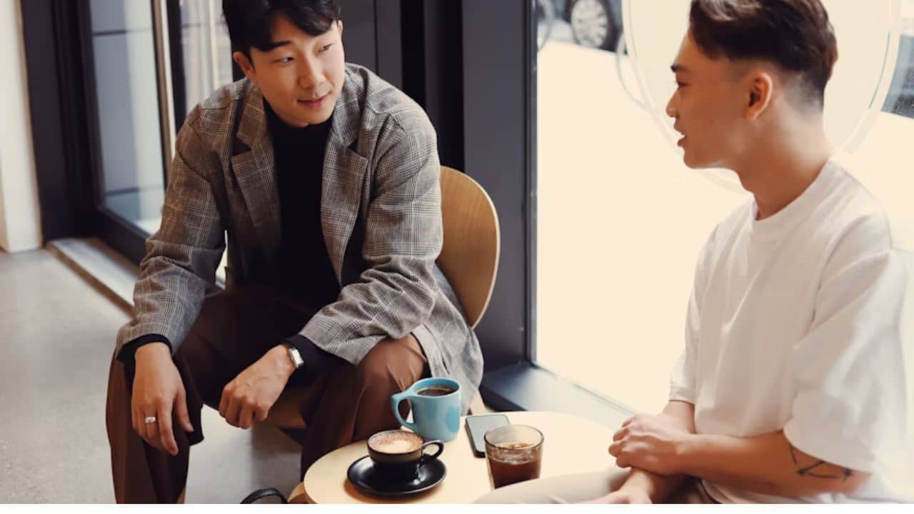 Two men having a heart to heart conversation over a cup of coffee.