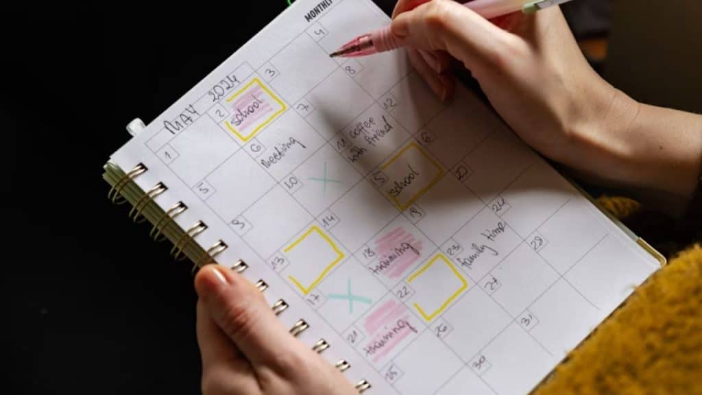 Man using a planner or calendar to map out daily energy cycles.