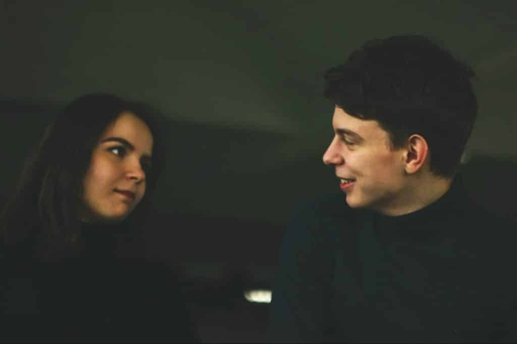 A woman not smiling to a man.