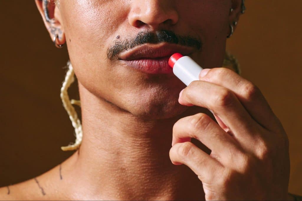 A man using a lipbalm.