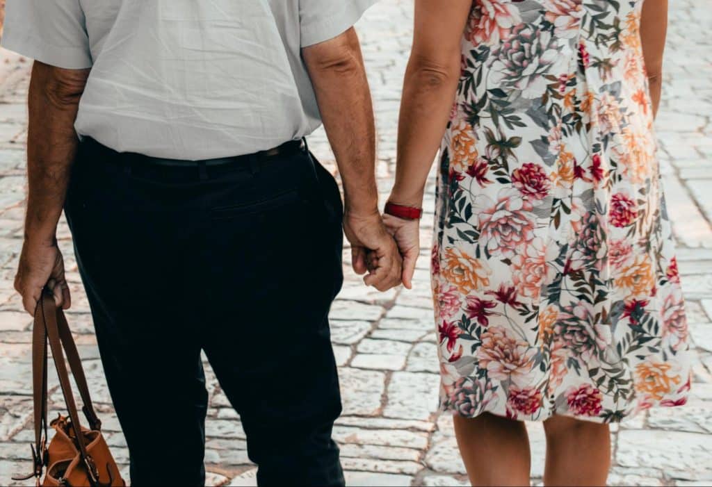 A man holding a bag of a woman