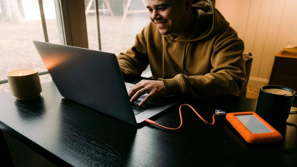 A man smiling while working alone