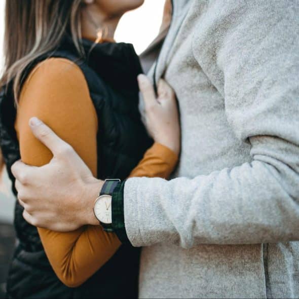 A man holding a woman for her to feel safe