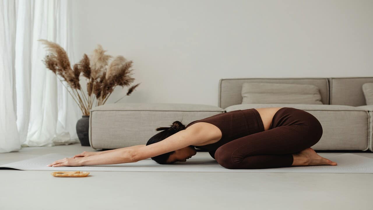 A woman doing yoga at home.