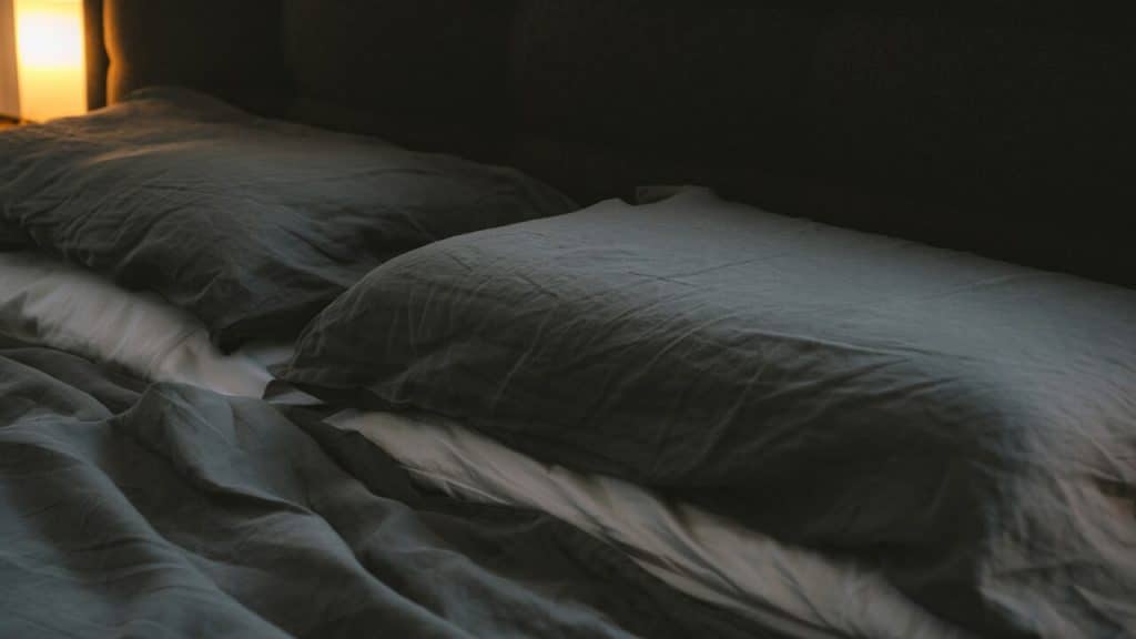 An empty bed at night