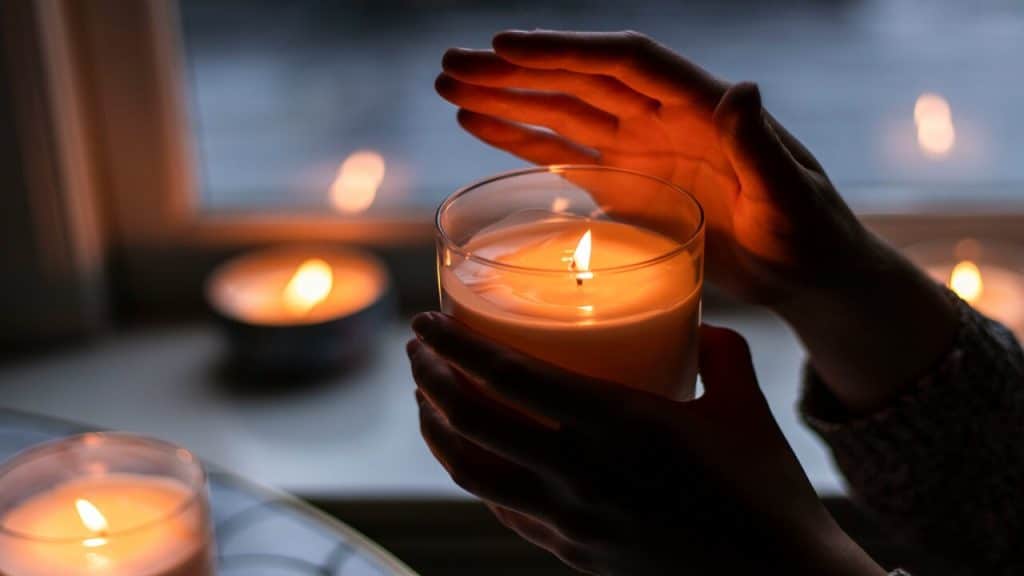 A woman lighting candles at home