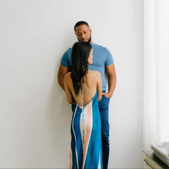 A woman leaning a man’s chest.