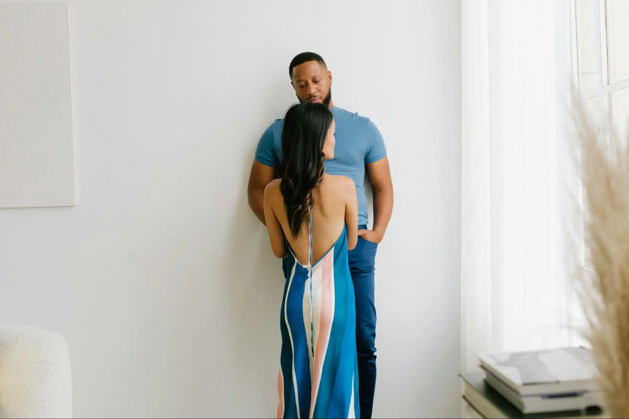 A woman leaning a man’s chest.