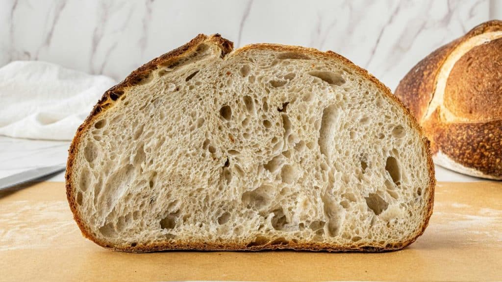 A sliced loaf of rustic sourdough bread.