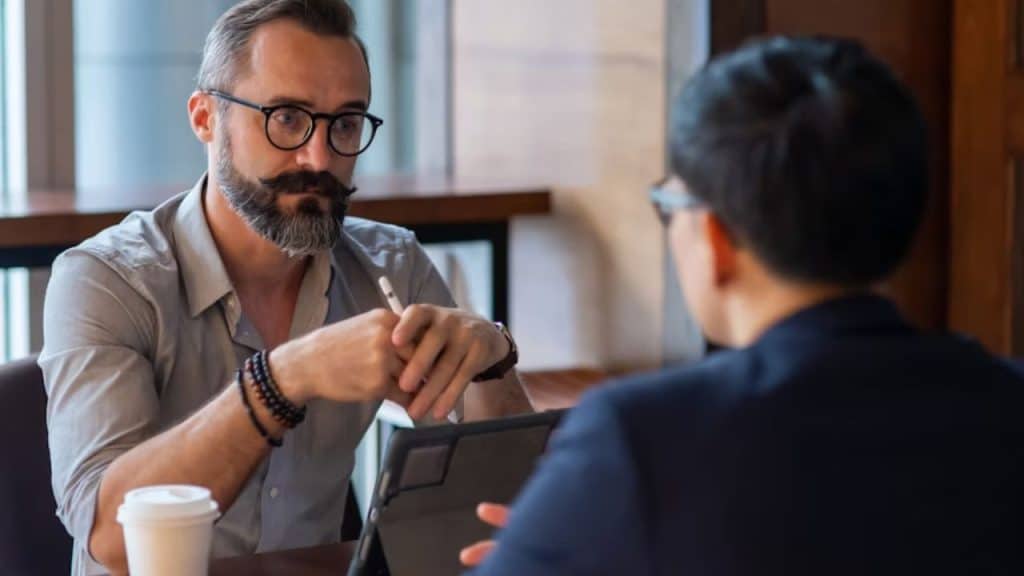 Man trying to hear conversation over restaurant noise