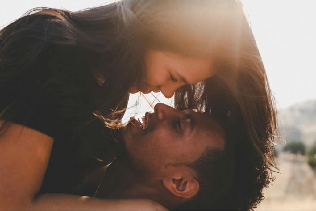 A picture of a man and woman being close together 