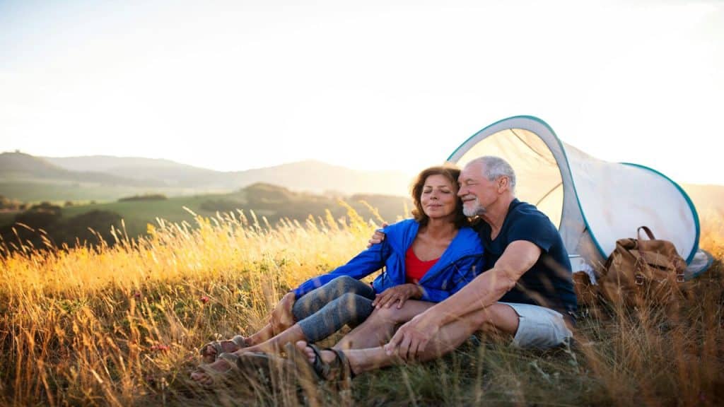 A mature couple camping tohether