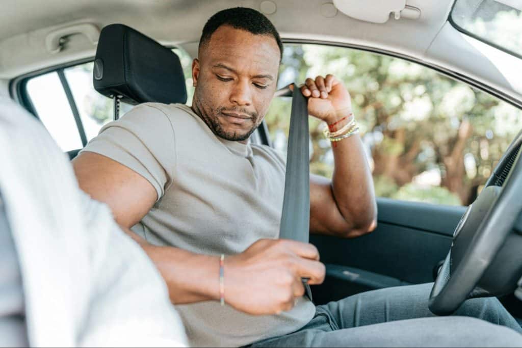 A man buckling-up a seat-belt
