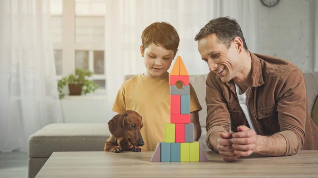 A father admiring his daughter’s heart-filled drawing.